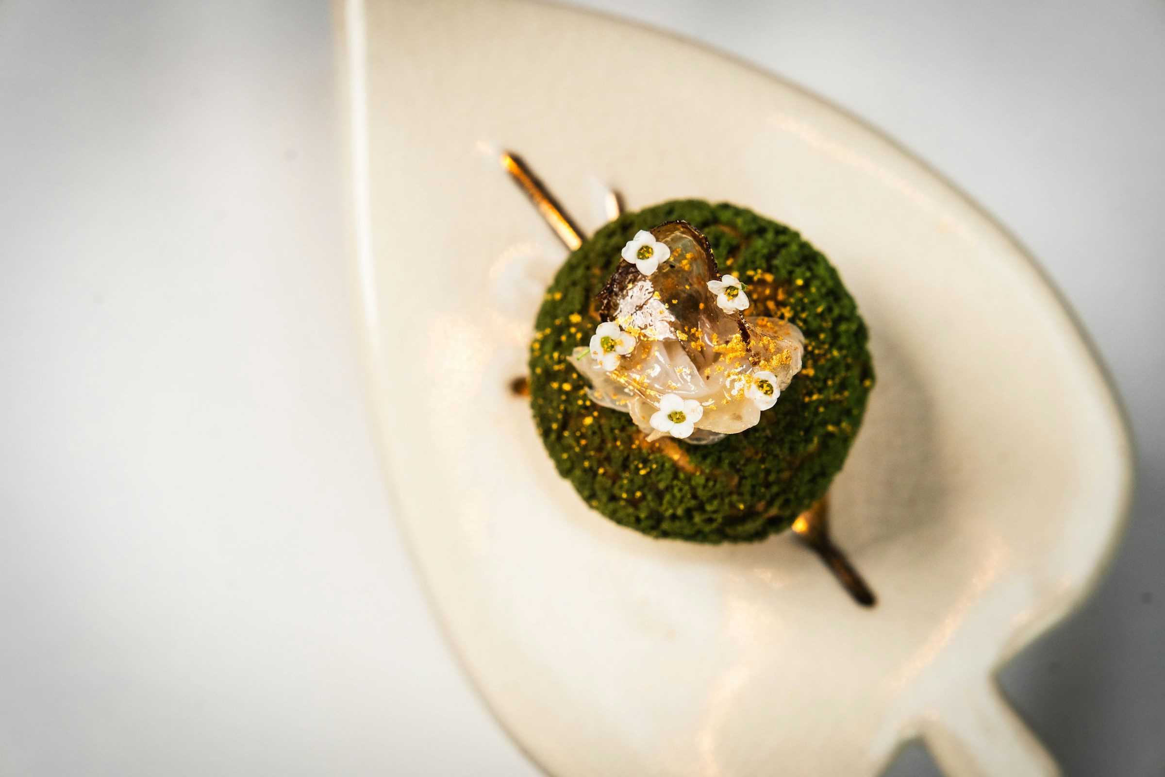 Miami Spice 2026 ultra-luxury restaurants: Reserve-tier tasting course plated with edible flowers and gold leaf on neutral linen