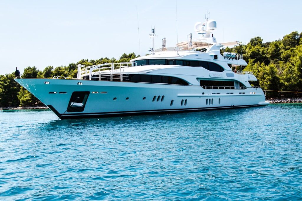 Luxury motor yacht anchored in turquoise Caribbean waters near a tropical island — Miami yachting 2026 editorial feature.