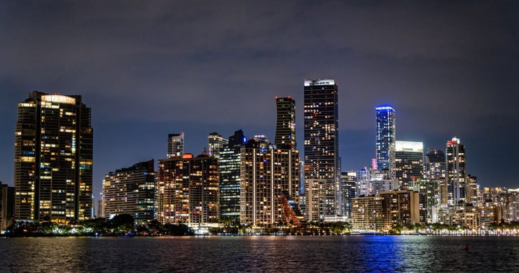 Miami skyline lit up at night across Biscayne Bay