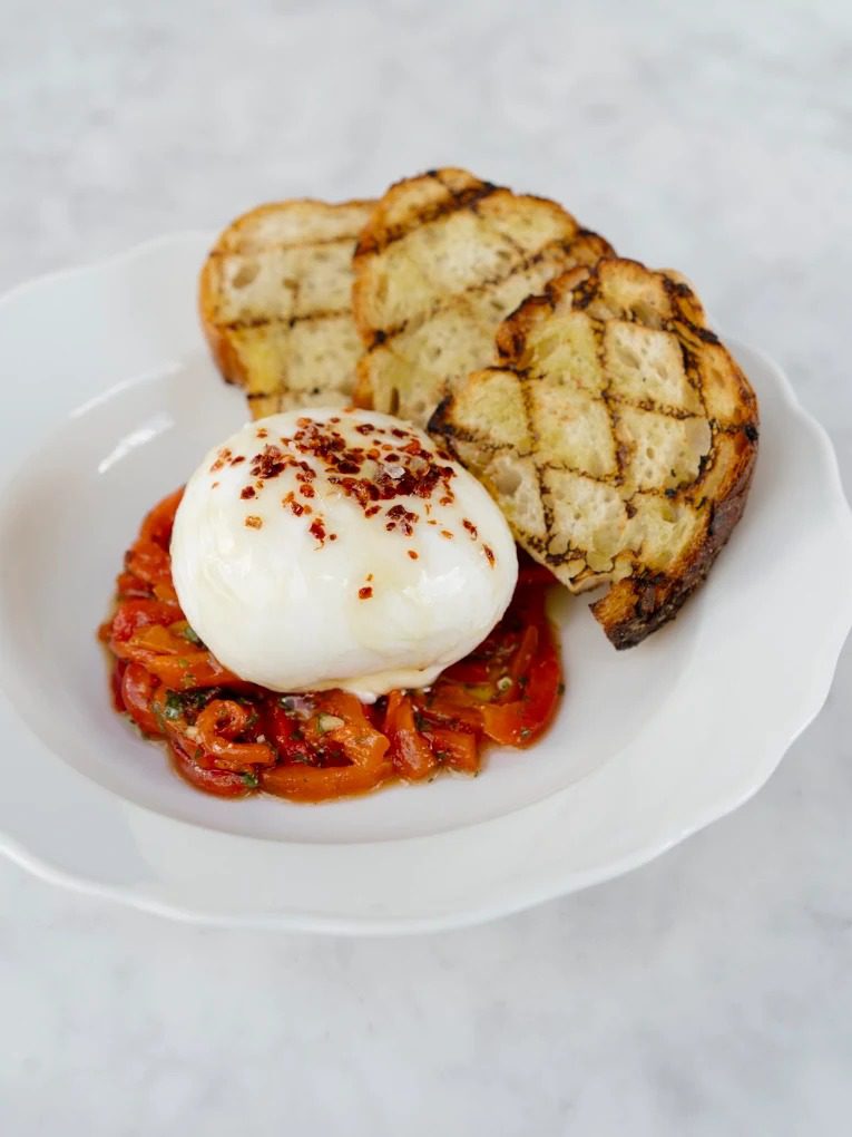 Burrata over marinated peppers with grilled Sullivan Street filone at Rosemary's Wynwood