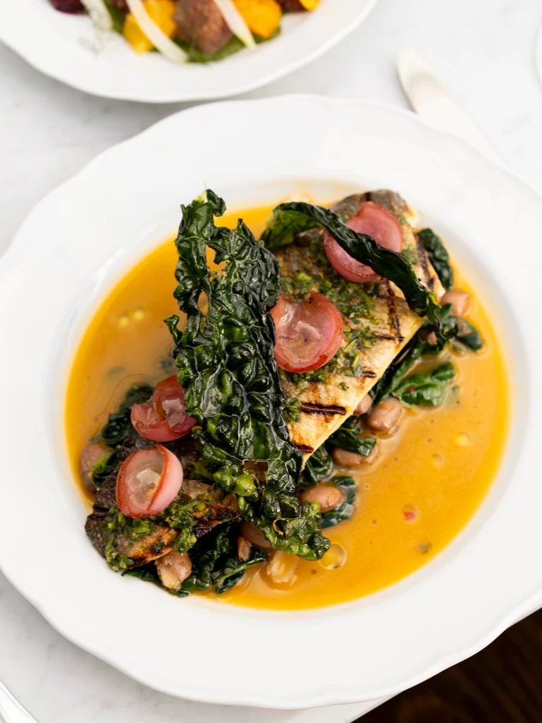 Grilled branzino with kale, borlotti beans and salsa verde at Rosemary's Wynwood