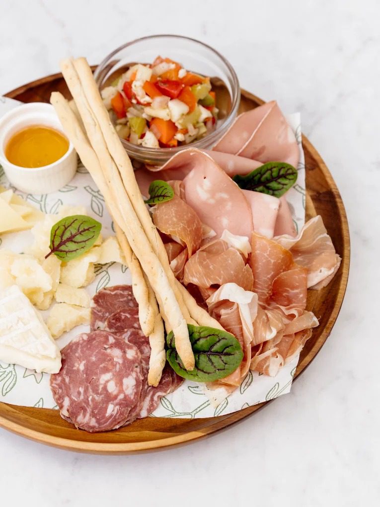 Italian salumi board with prosciutto, mortadella, aged cheese and grissini at Rosemary's Wynwood