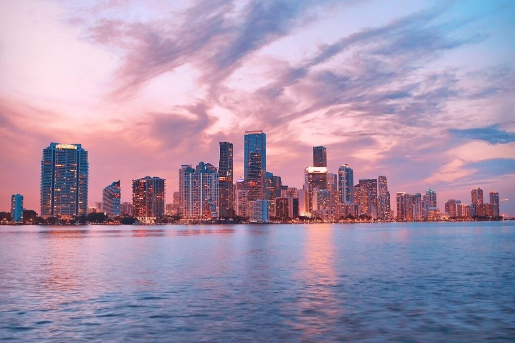 Quiet Miami waterfront with palm trees and a calm bay at golden hour, showing the hidden peaceful side of the city