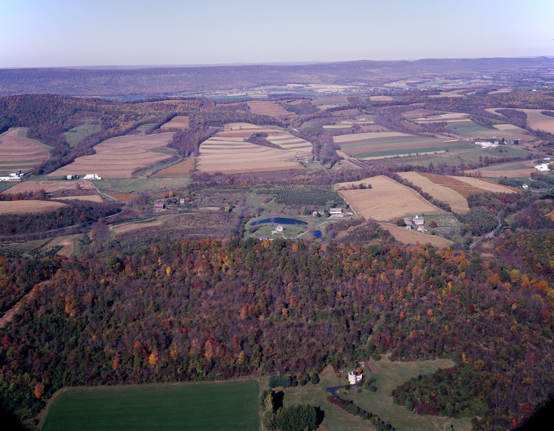 Aerial view of cultivated farmland showing geometric field patterns