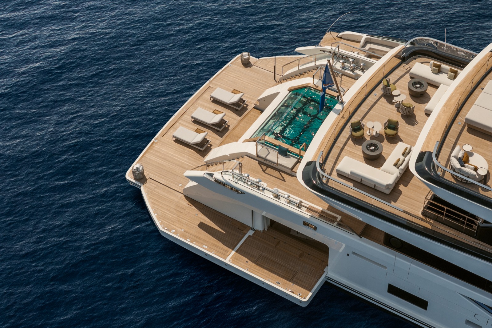 Wellness area on the Sanlorenzo 74Steel showing the glass-bottomed pool that lights the beach club from the main deck above