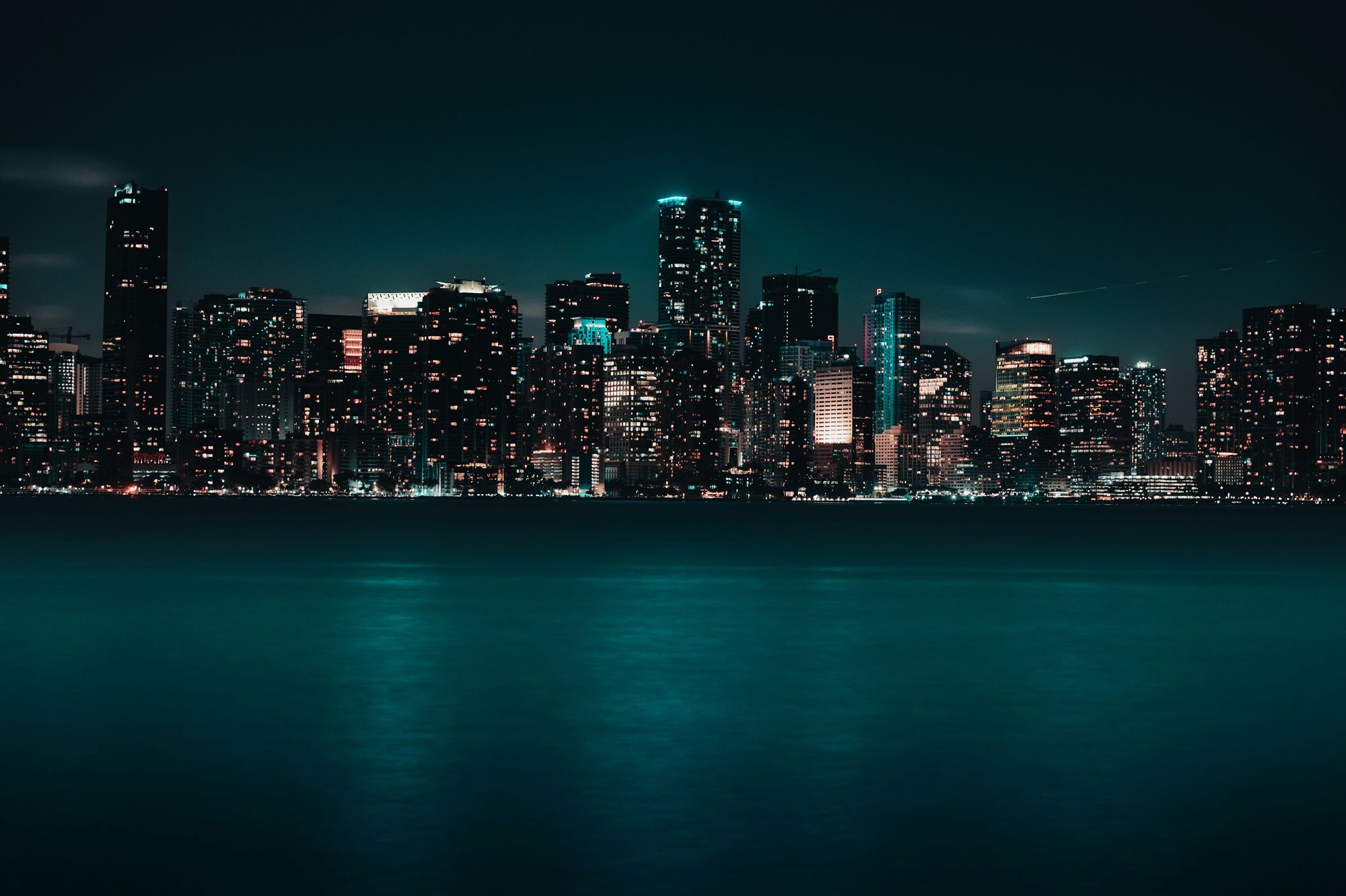 Miami skyline at night reflected on the water